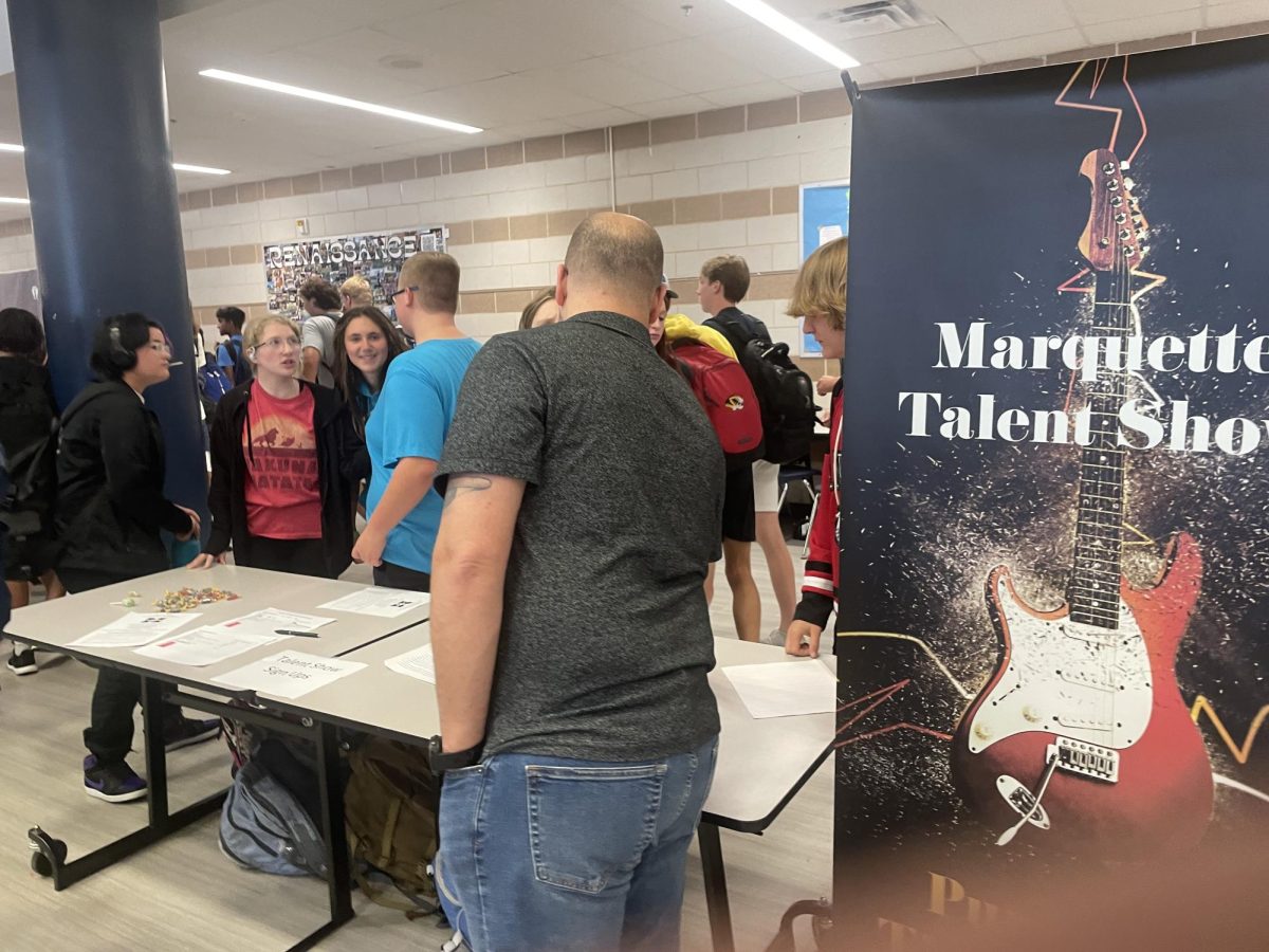 Students+interact+with+teachers+and+students+at+the+Marquette+Talent+Show+table.