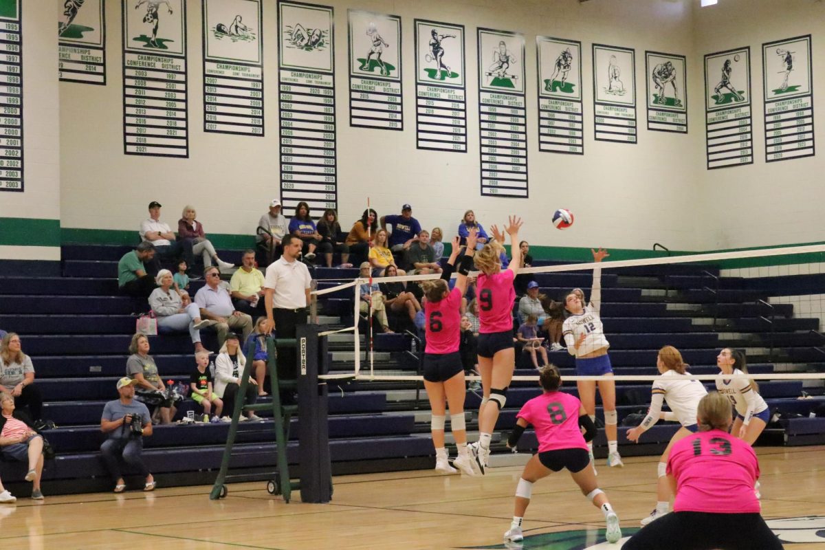 Seniors Mia Scanlon and Jacey Young block a spike at the net while Junior Ella Keeven prepares for a deflection in a home game against Francis Howell on Friday, Sept. 8. Both Scanlon and Young have committed to play volleyball in college. 