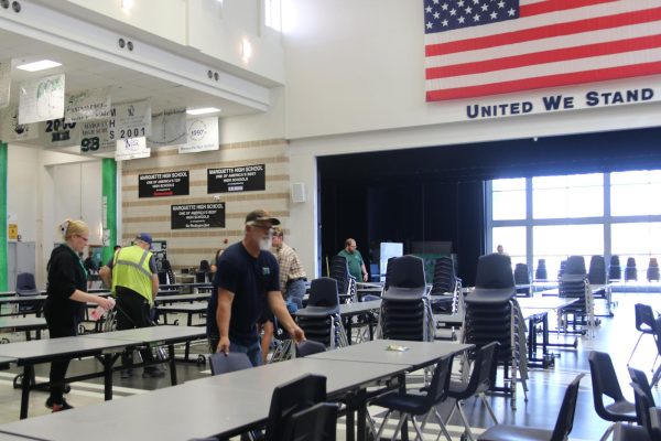 Randall Ray, custodial head, cleans tables along with other members of the custodial and lunch staffs between lunches. A shortage of custodial workers has prompted the district to pursue hiring students before and after school to help clean the building.
