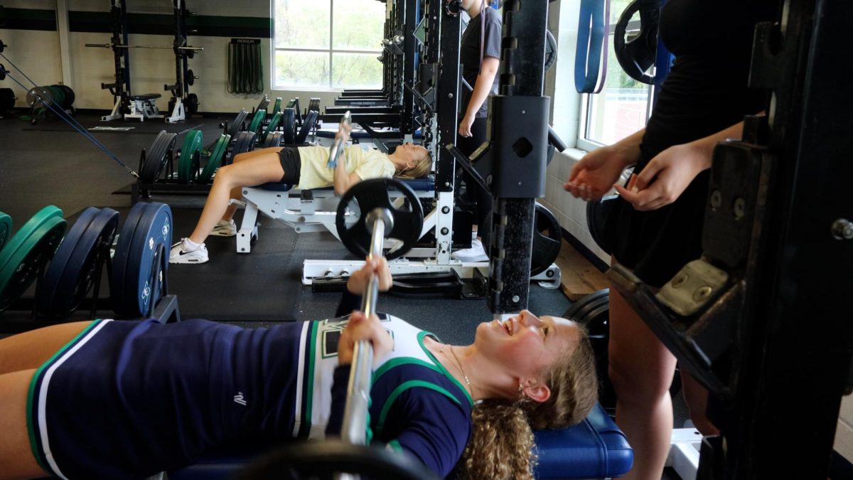 Kaitlyn Johnson, sophomore, bench presses in fifth hour Advanced Strength Training. The weight room is one of the more recent renovations in the academic building and features space, natural lighting and new equipment.