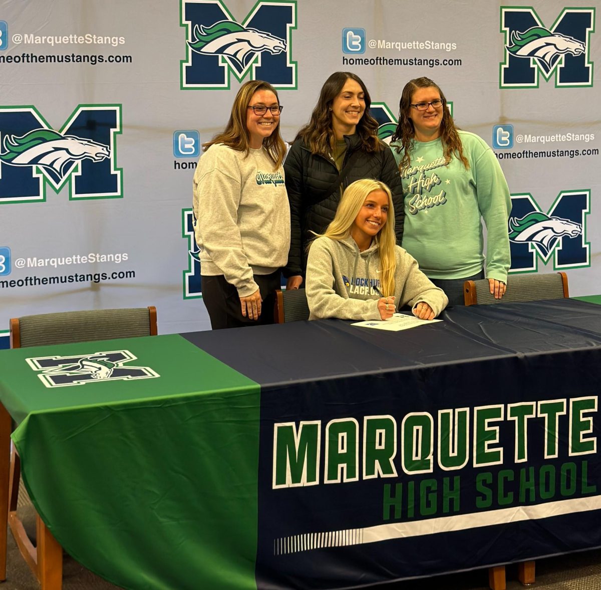 Katie Morgenthaler, senior, poses with MHS lacrosse coaches Marissa Albanello, Renee Abrolat and Katherine Schroeder during Winter Signing Day on Monday, Nov. 27.