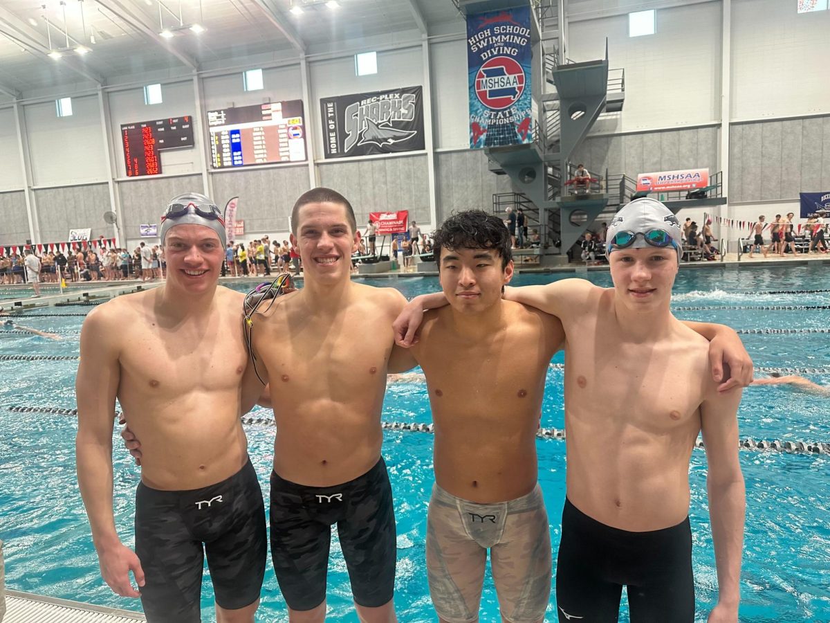  From left to right: Jack Favazza, senior ; Vincent Hagar, junior ; Max Xu, junior ; Braden Scherrer, senior. The four swimmers pose after beating the Marquette relay record by 300 milliseconds. 
