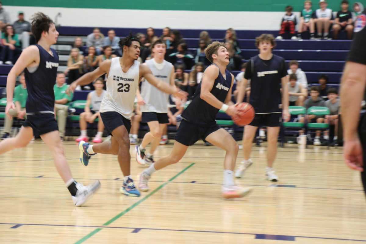 Kieran Burnett, junior, approaches the basket for a layup during the boys varsity scrimmage on Friday, Nov. 17.