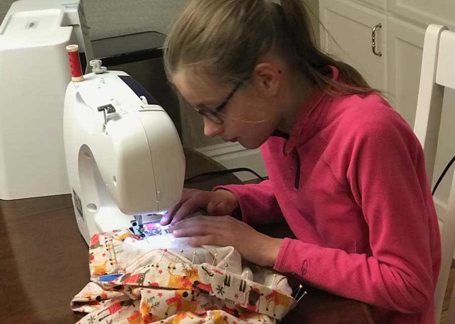 Samantha Perz, sophomore, sews a pair of holiday pajamas when she was younger. This tradition started when she was about 9 years old.
