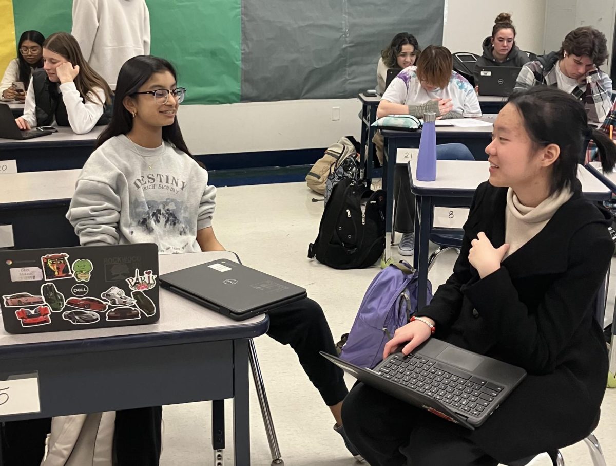 Ivy Wang, sophomore, talks to Sneha Deo, sophomore, in Room 220. This is the same room where Model United Nations meets, one of Wangs fondest activities from 2023.