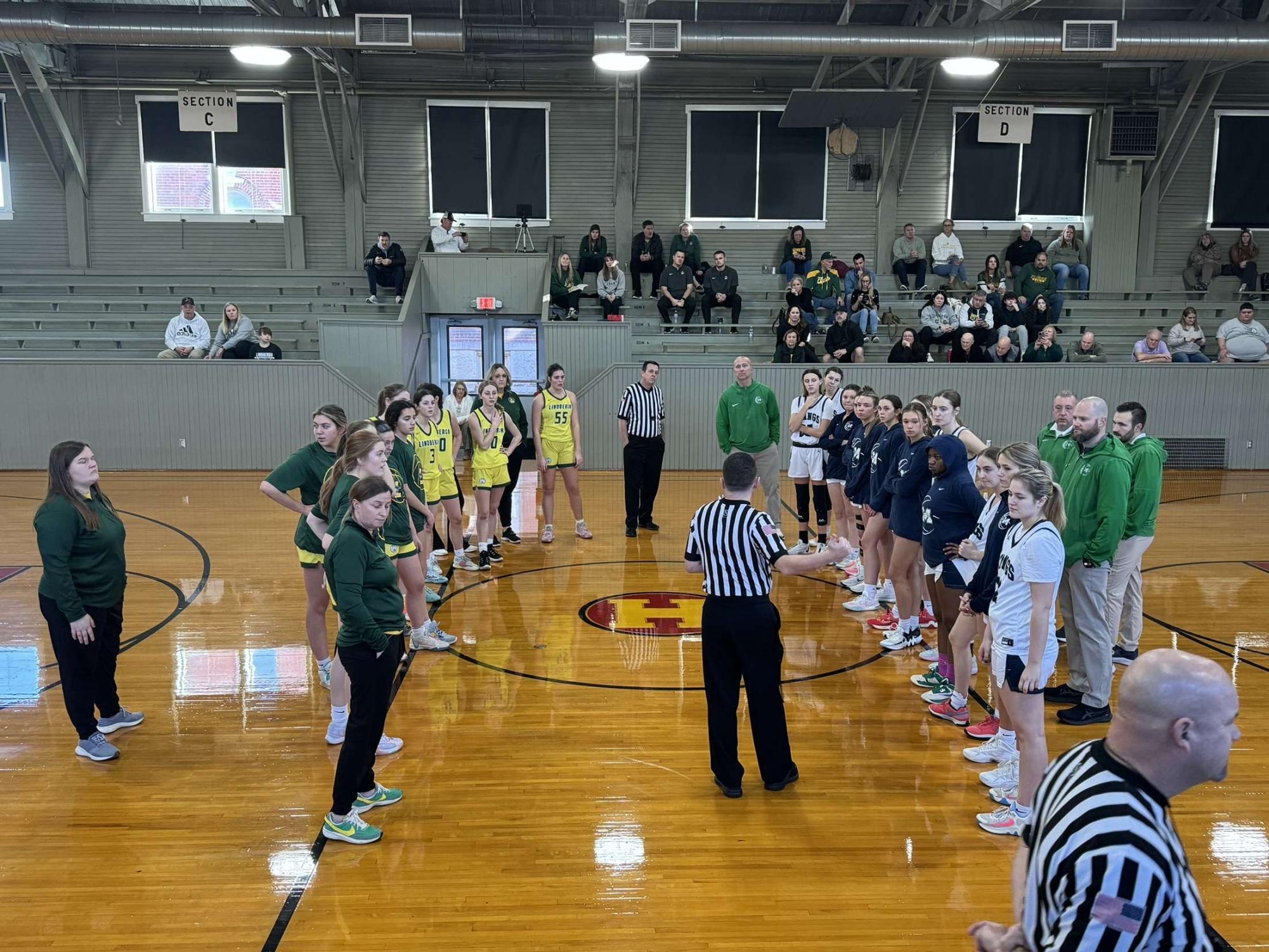 Lindbergh High School and MHS line up at half-court in the historic Hoosier Gym in Knightstown, Indiana, before tip-off on Saturday, Feb. 3. MHS went on to take a 58-40 victory. 