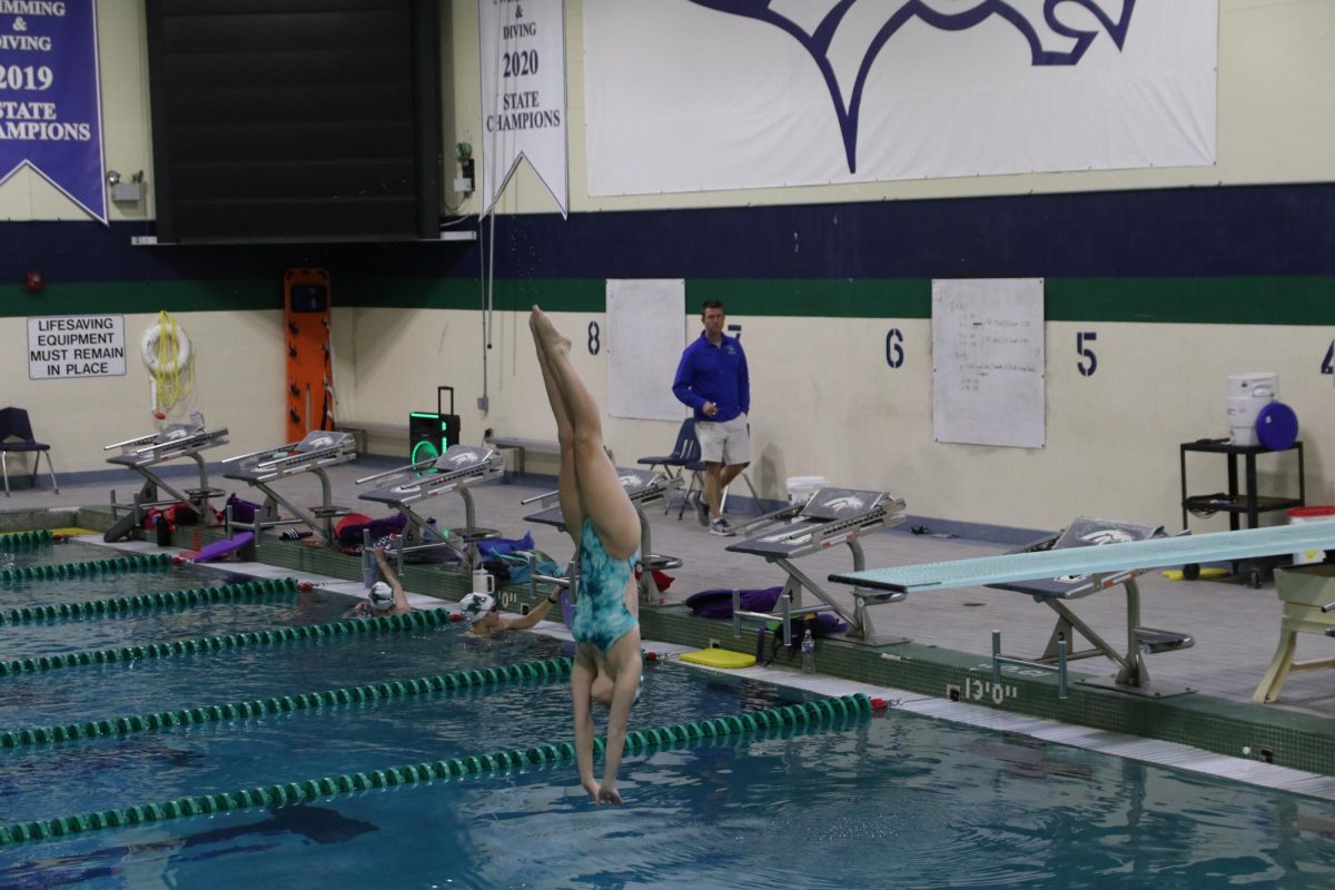 Becca Myers, junior, practices her dives before State on Feb. 15. Myers placed 22nd at State on Feb. 17.