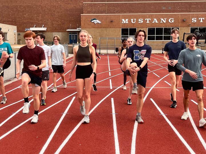 Logan Presnell, senior, and Maleah Eggers, junior, warm-up with the winter running club on Thursday, Feb. 1