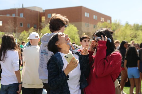 Juniors Anvita Rani and Apurva Ganti witness the solar eclipse on Monday, April 8, alongside all students, faculty and staff. During today’s eclipse, only 98.3% of the sun’s visible light will be blocked, so the sky won’t darken. Wearing solar eclipse glasses was highly recommended to protect viewers’ eyes. 