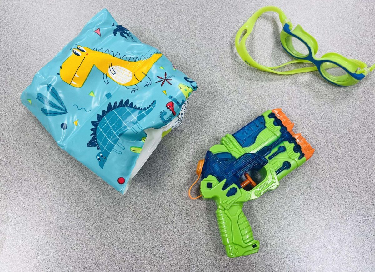 Goggles, water gun, and floaties are all used to eliminate students and remain safe while playing Senior Assassin
