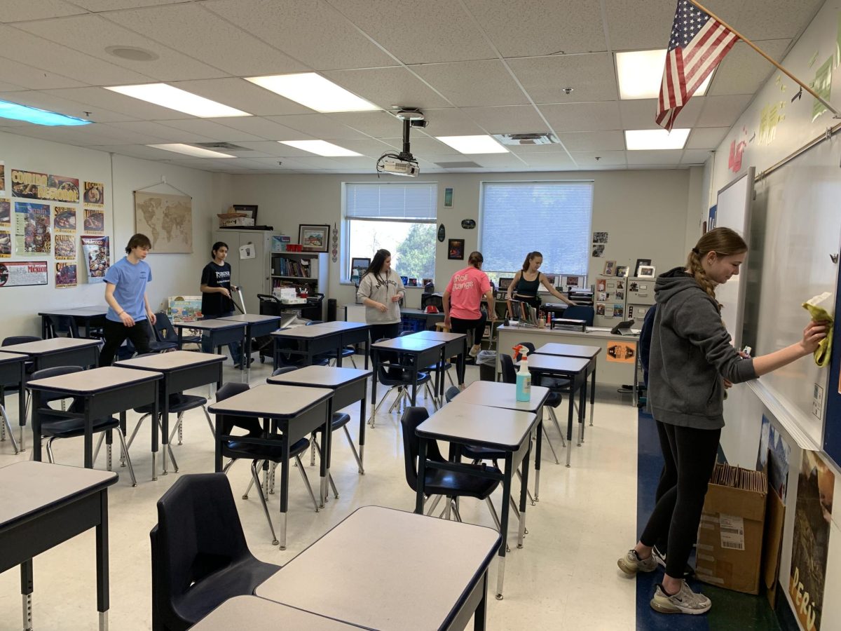 Students and staff work together to clean G23 as part of Marquettes first Spring Cleaning. Participants spent the day wiping down chairs, tables and windows and mopping the floors of 116 classrooms.