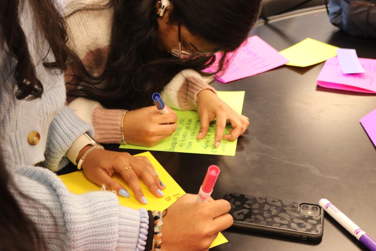 Riya Kothakota, junior, works on a card during a NAMI meeting, which were sent to the Letters Against Depression organization. These cards were distributed by the organization and were made to support and comfort individuals with mental illnesses. 