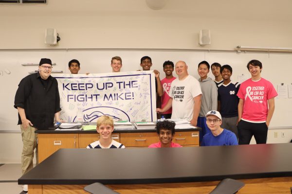 After Mike Wagner, science teacher, was diagnosed with cancer earlier this semester, the tennis team presented him with a banner filled with signatures of support from the community. The team had planned a fundraiser but it was canceled due to rain.