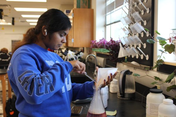 Anagha Mandadi, senior, is the teacher aide for an ASR 2 class. Next to the sinks, she measures agar for Dr. Cathy Farrar to use for her science classes. The administration suspects that blockages in the science wing drains are causing a foul odor.