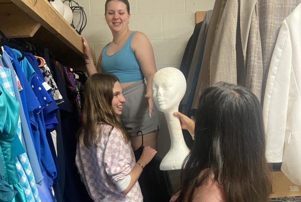 Sophomore costume crew members Molly Fitzpatrick, Karina Ramirez and Brooklyn Merker put the extra theater wigs in a storage bin in order to maximize space in the already cramped costume closet. They do this so that all of the wigs are easily accessible.