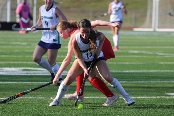 Brynn Traxler, senior, battles for the ball. She planted her feet and won
possession, successfully defending against a Kirkwood player.