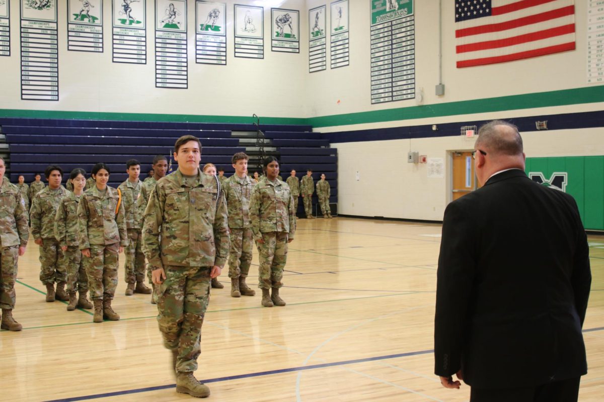 Lieutenant Colonel Brian Buck, Region Director for Air Force Junior ROTC, inspects AFJROTC in the large gym on Wednesday, Oct. 30.
