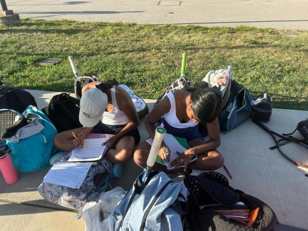 Girls tennis players work on their homework during a match. Students often juggle sports, schoolwork and other activities, and sometimes this load becomes excessive. Despite the pressure to be involved in everything, students need to prioritize a few areas they are passionate about to be successful.
