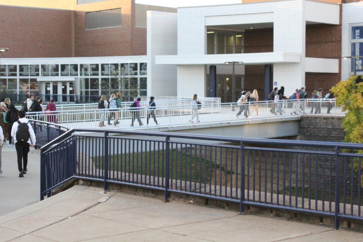 Students stream into the building before the starting bell rings at 8:28 a.m. To accommodate the return of teacher professional development during the school year, the 2025-26 school year will see classes start 7 minutes earlier.