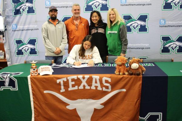 Ella Keeven, senior, signs with her family and coaches on signing day Monday, Dec. 2. Keeven is committed to the University of Texas at Austin to play beach volleyball.