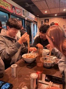 Seniors Henry Chen, Arush Singh, and Riley Gregory eat ramen together at Menya Rui after waiting in line for two hours.