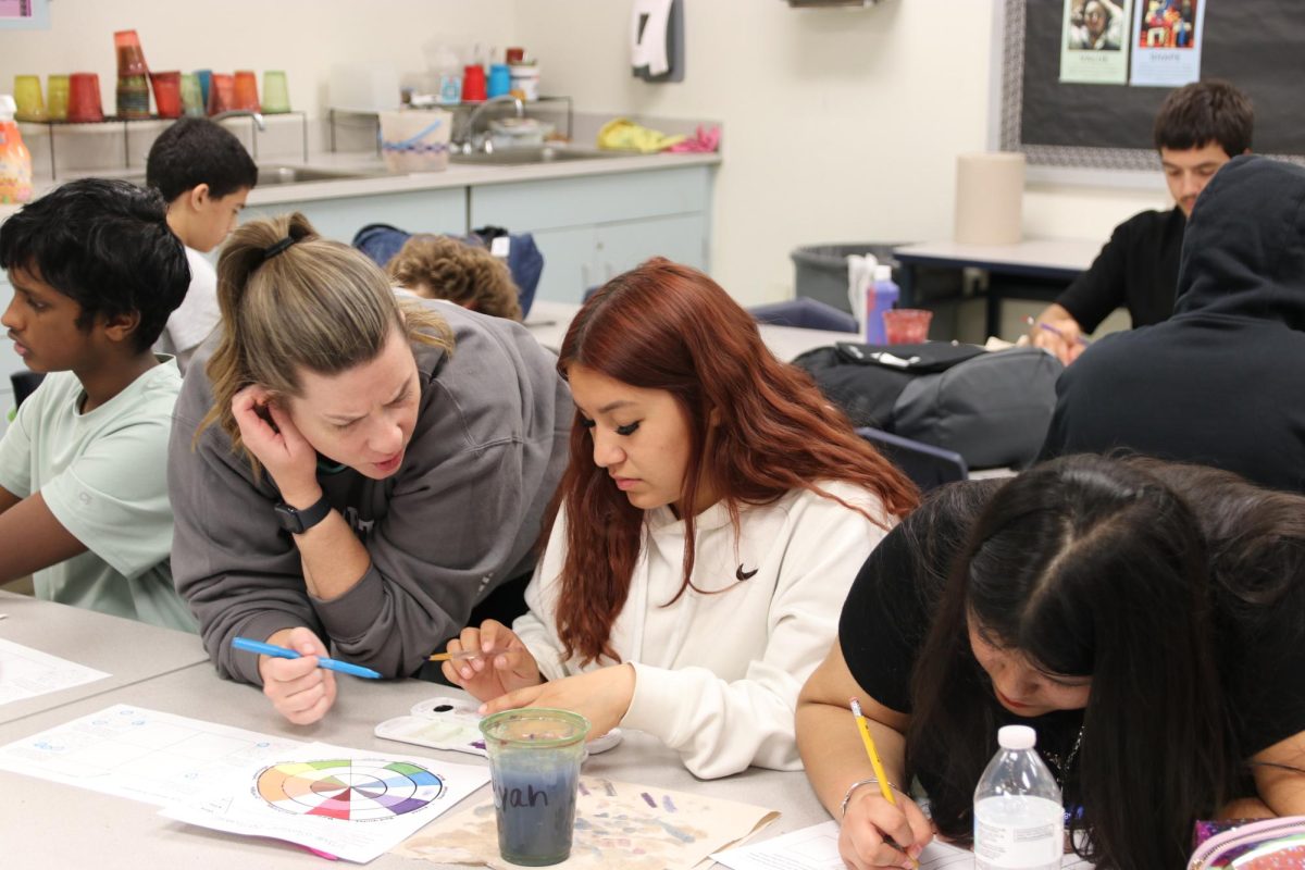 Abbey Gradle, art teacher, helps Norma Becerril Martinez, sophomore, during her fifth hour Art Fundamentals class on Thursday, Sept. 18. Prop S would also be used to expand healthcare benefits and hire two more school safety officers.