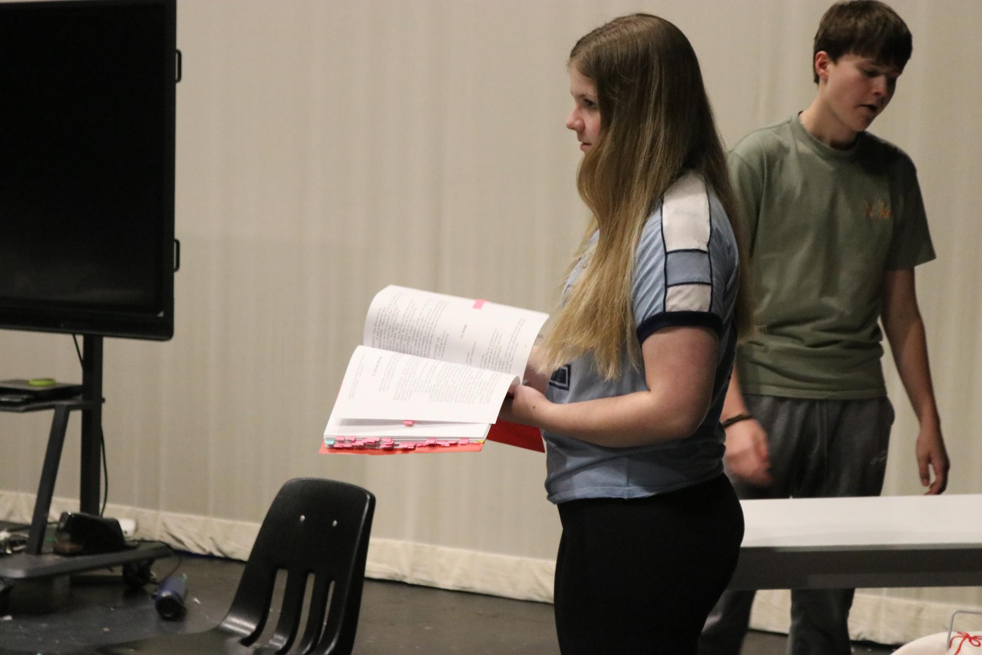 Molly Fitzpatrick, junior, prepares her script before she acts out her lines in "The Curious Incident of the Dog in the Night-time" through Chaminade College & Preparatory School. As Mrs. Shears, she has spent a lot of her time mastering the role.