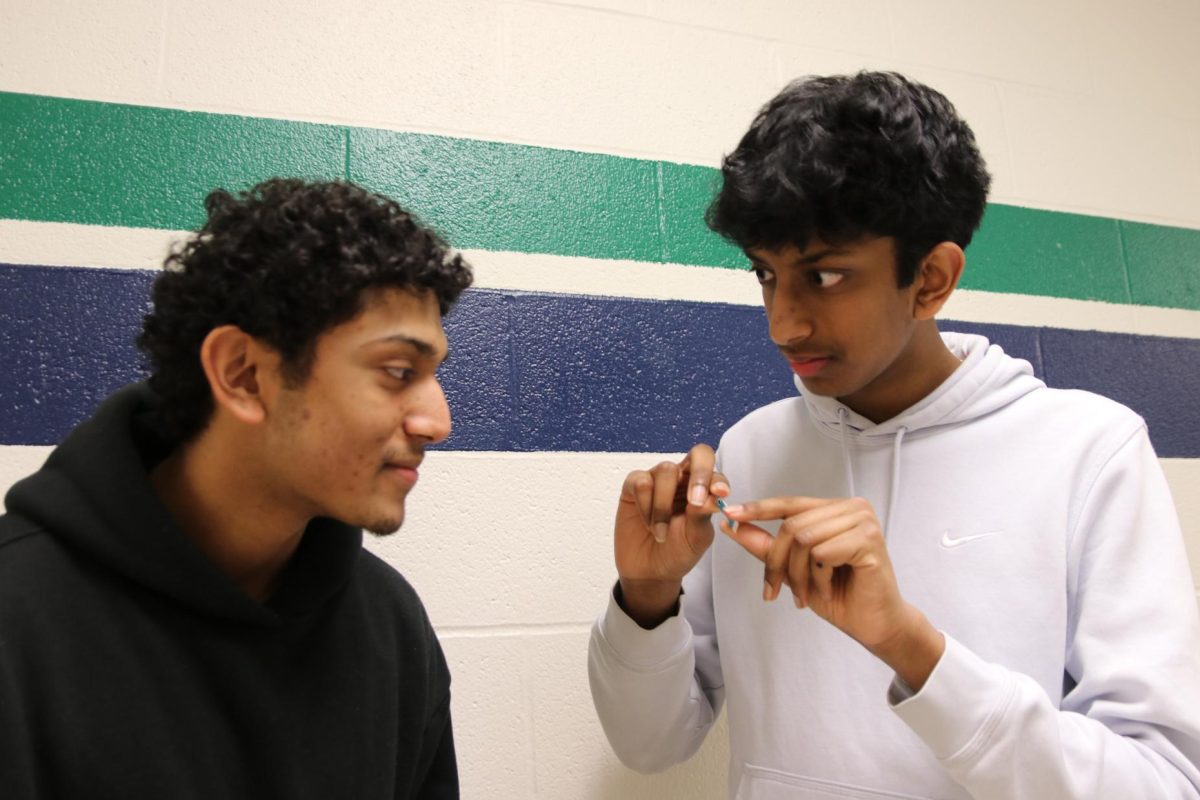 Juniors Harshith Akurati and Ayush Vasireddy look at Vasireddy's sensor, called the Hierarchical Bimodal Nanoporous Gold. Vasireddy will present this sensor at the International Science and Engineering Fair (ISEF) in May. 