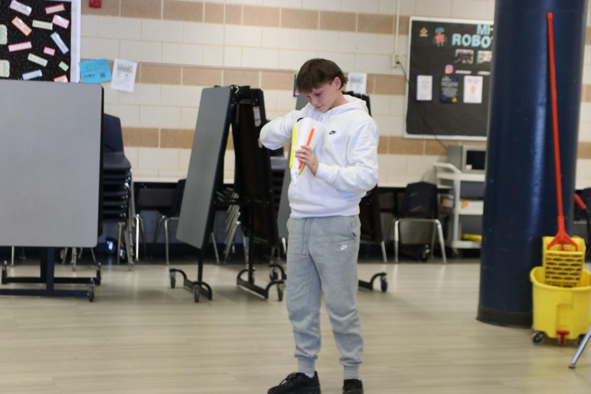 Hudson Williams, junior, opens his delivery system to see if his egg broke. If his egg cracks, he will get a performance score of zero. Performance scores are increased by having eggs that do not break, that are small in size and time of flight and that are closer to the bullseye.
