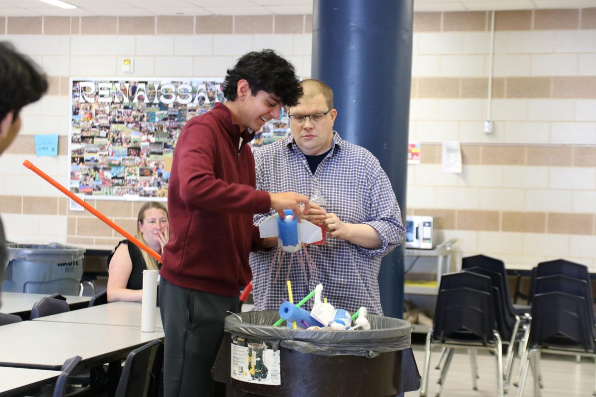 Devansh Sharma, sophomore, grins as he opens up his delivery system to discover that his egg hasn’t cracked. Sharma held his delivery system over a trash can in case his egg had cracked.