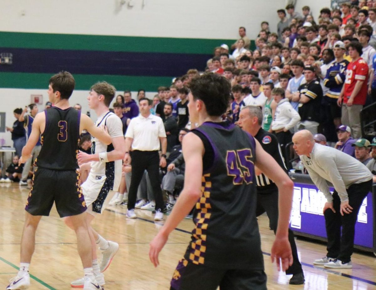 Derek Hoffman, varsity boys basketball coach, watches as the opposing team plays during a game against Eureka. This game was a part of the Class 6 District 2 Tournament.